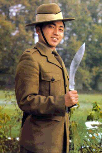 a young Gurkha presents arms